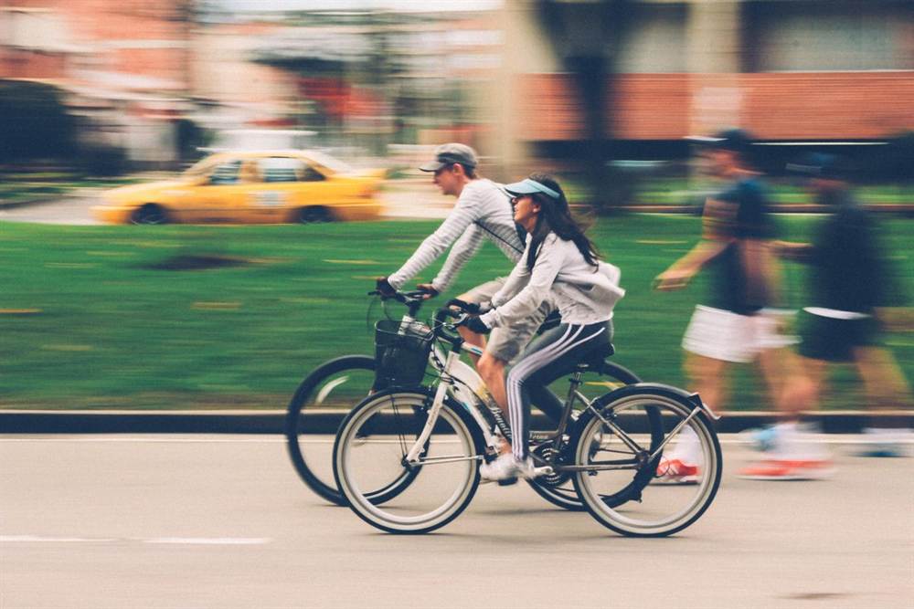 Couple cruising through town on city bikes